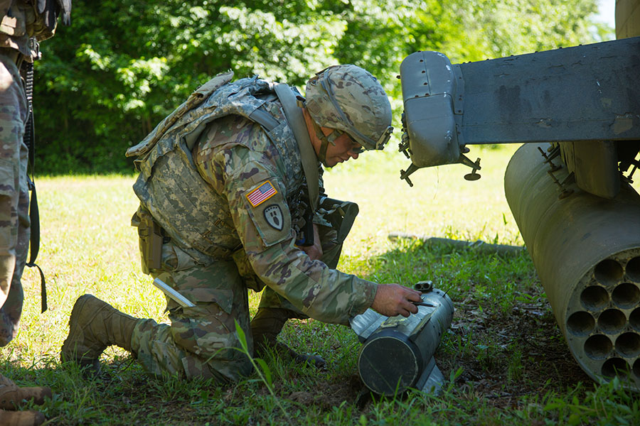 Explosive ordnance disposal team leader works disarm simulated explosives on the crash site lane at Fort Walker.