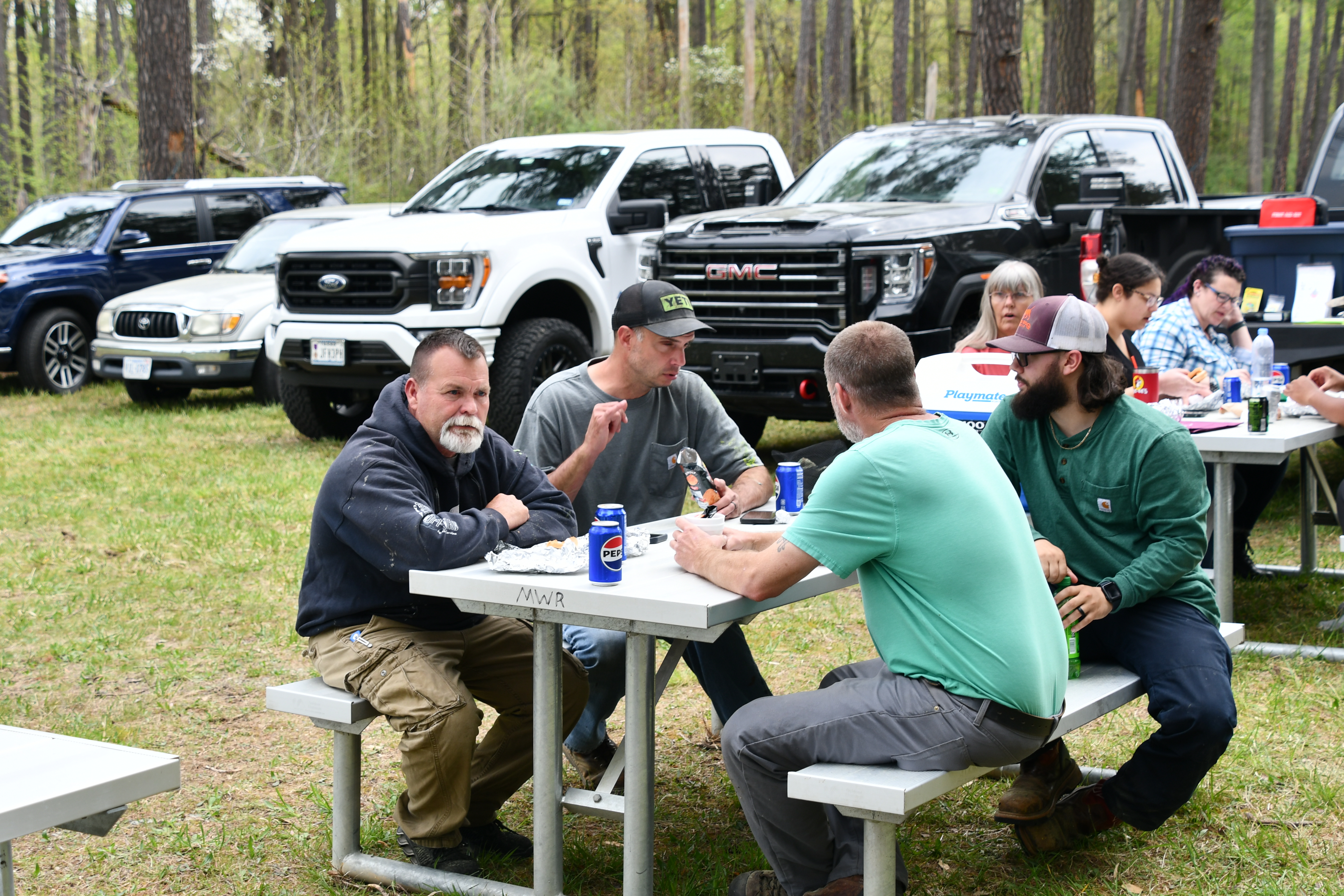 L to R, Troy Thomas, Jones Bolt, Bobby Martin and Cody Limbrick all enjoy an outdoor barbecue lunch cooked by the Department of Family, Morale, Welfare and Recreation on 17 Apr, at the Fort Walker grand re-opening of their paintball course.