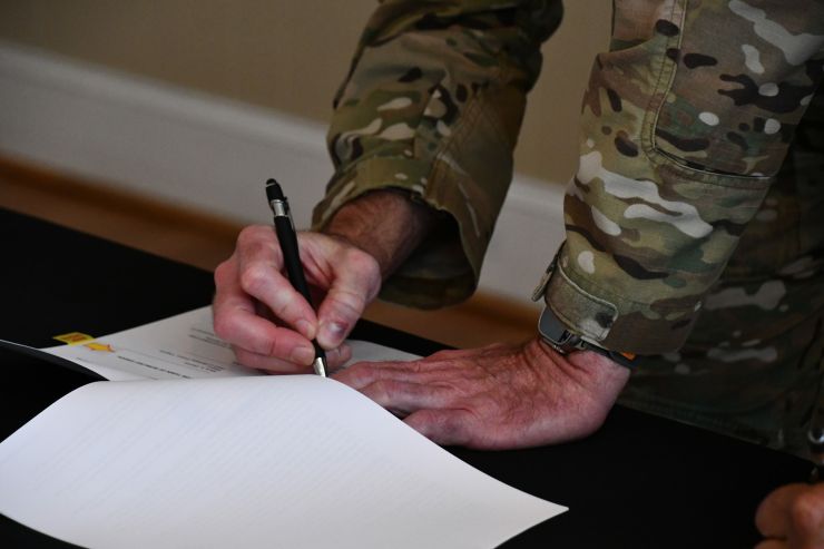 Lt. Col. Jason Duffy signs the general contracting IGSA between Fort Walker and the Town of Bowling Green on 20 June, 2024.