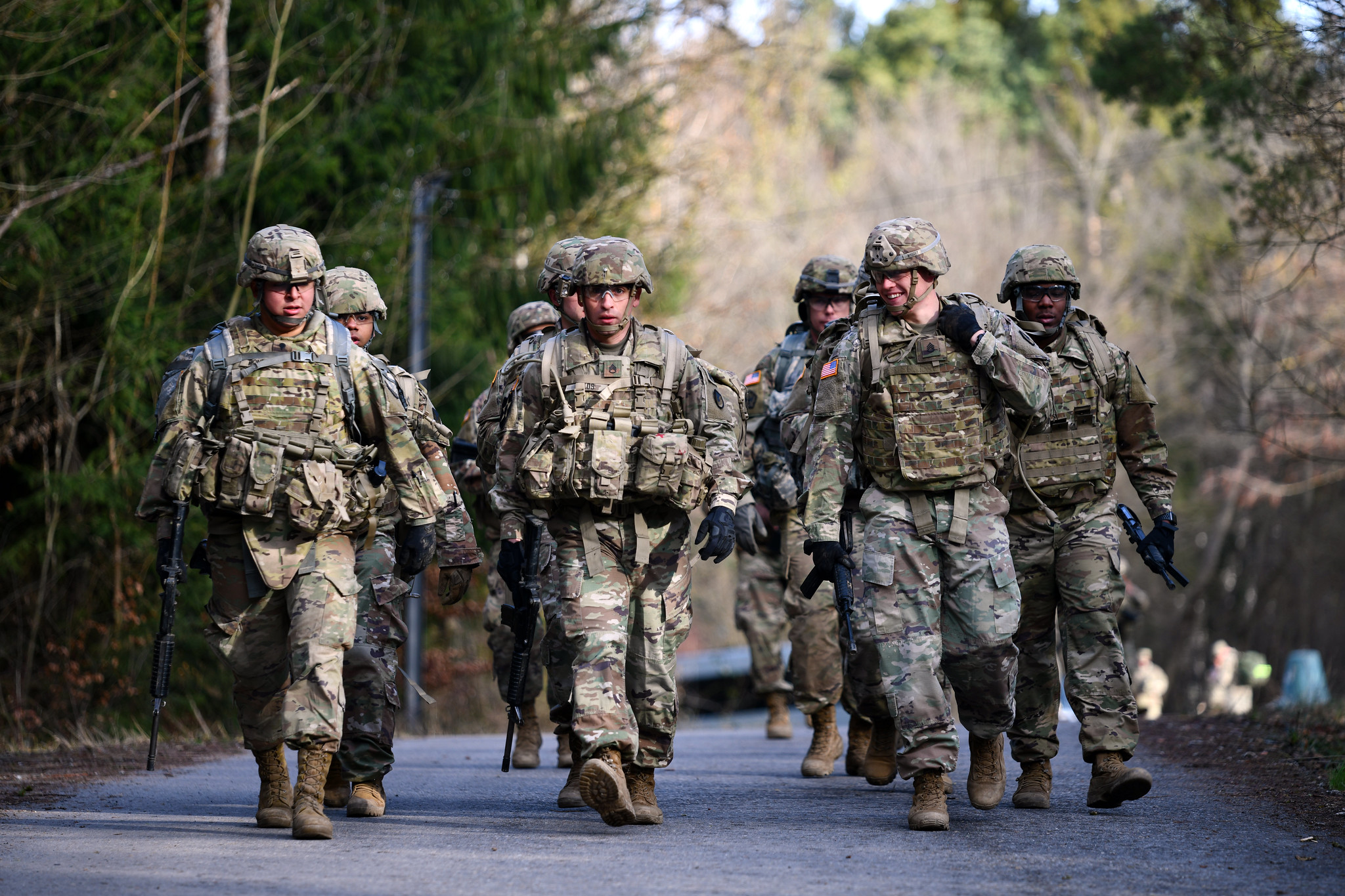 A photograph soldiers walking down a street