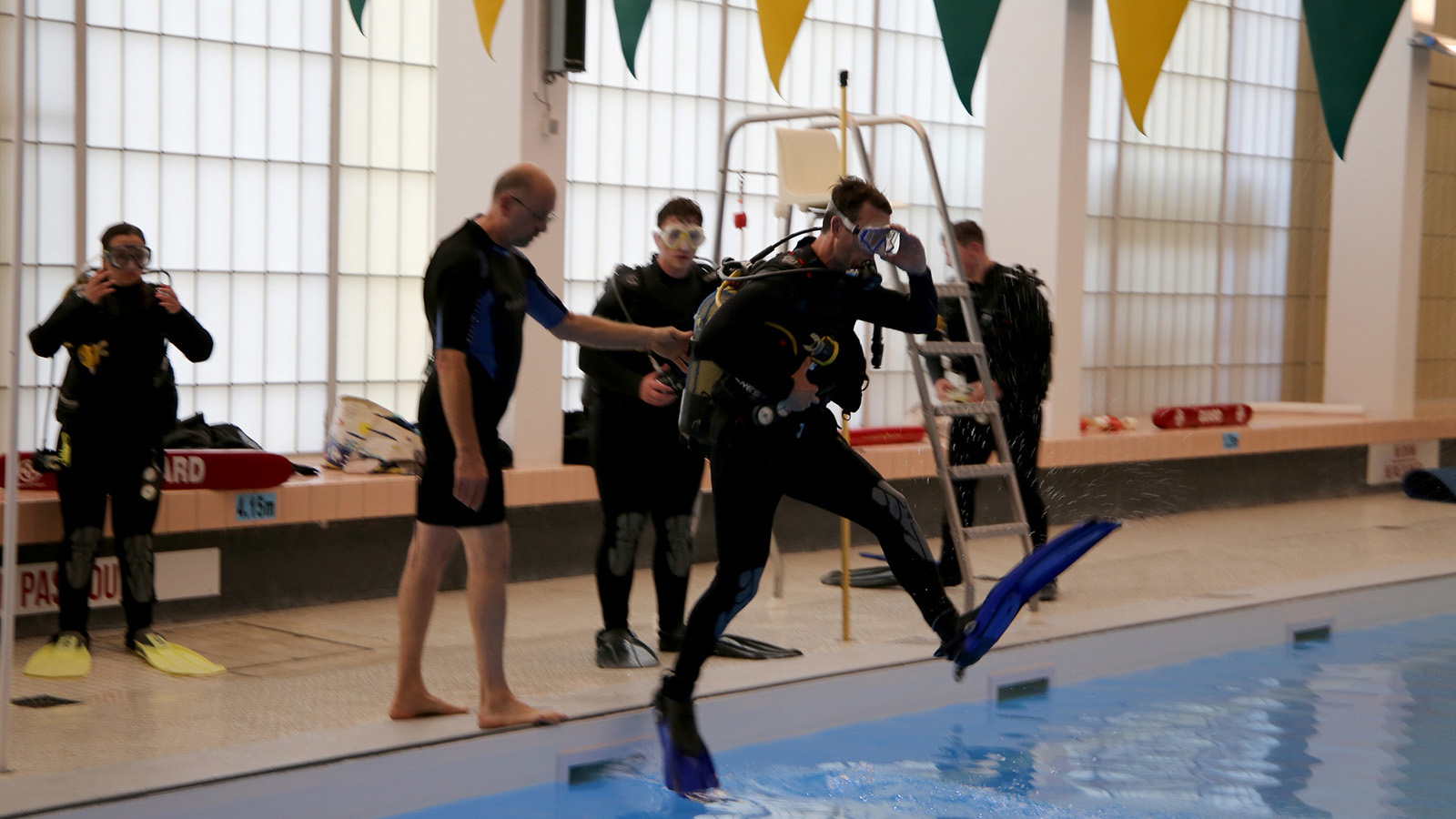 A photograph of people learning to scuba dive