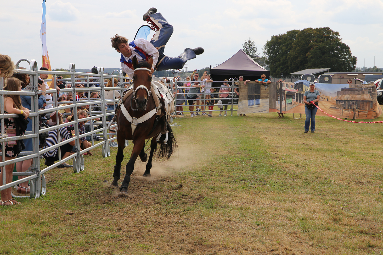 A photo of a man doing acrobats on a horse