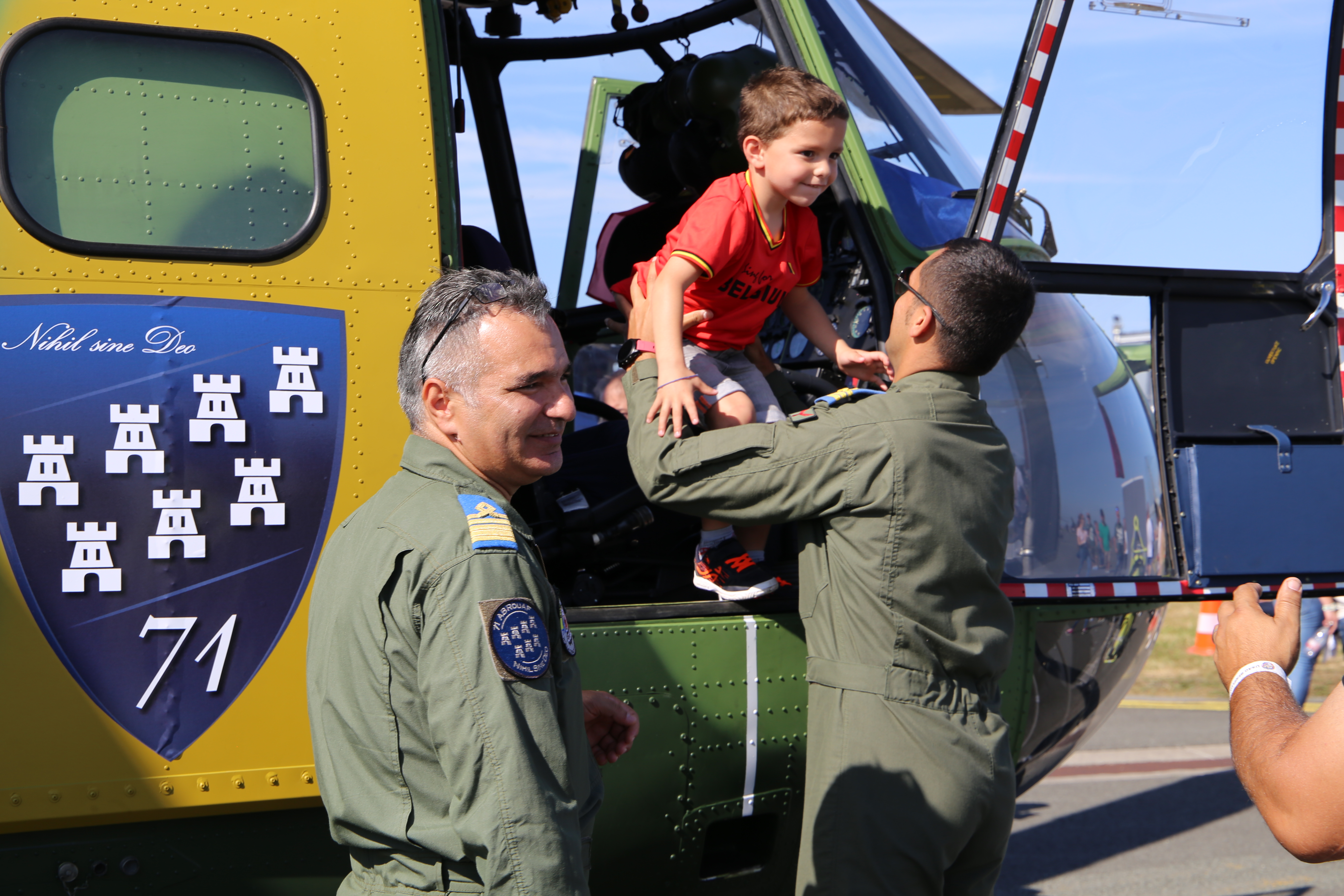 a photograph of a child getting a tour of a plane