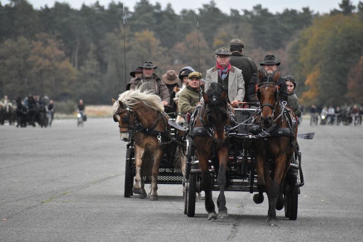 A photograph of a carriage full of people