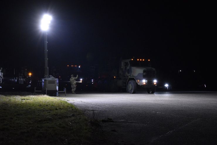 Rolling out The first few Bobtail truck tractors roll out March 10, 2022 from Zutendaal Army Depot, Belgium, under the glare of floodlights. (U.S. Army photo by Bryan Gatchell)