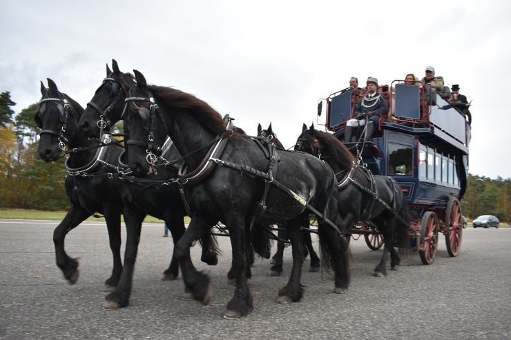 A photograph of a double decker horse drawn carriage