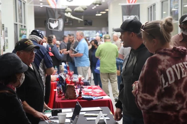 U.S. military retirees, spouses, and the Family members talk with various agencies and vendors during the annual Retiree Appreciation Day on Oct. 1, 2022.