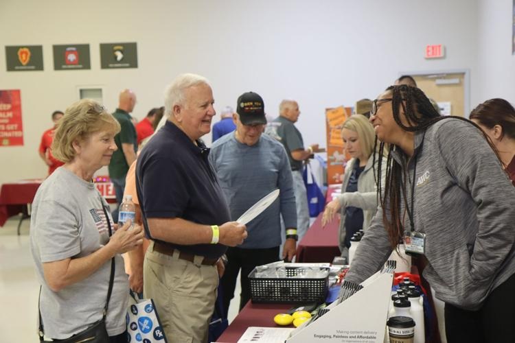 U.S. military retirees, spouses, and the Family members talk with various agencies and vendors during the annual Retiree Appreciation Day on Oct. 1, 2022.