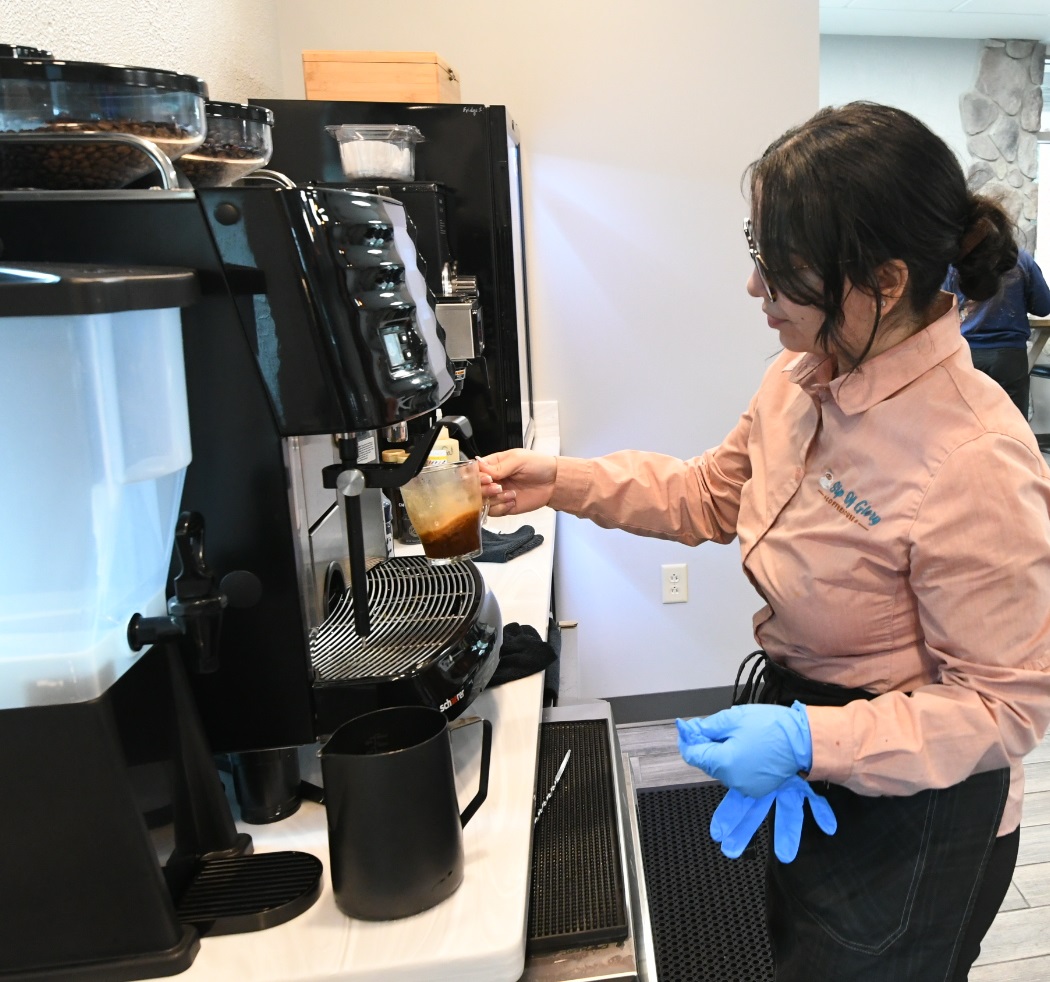 Barista prepares a hot beverage inside new coffeehouse on Fort Drum.