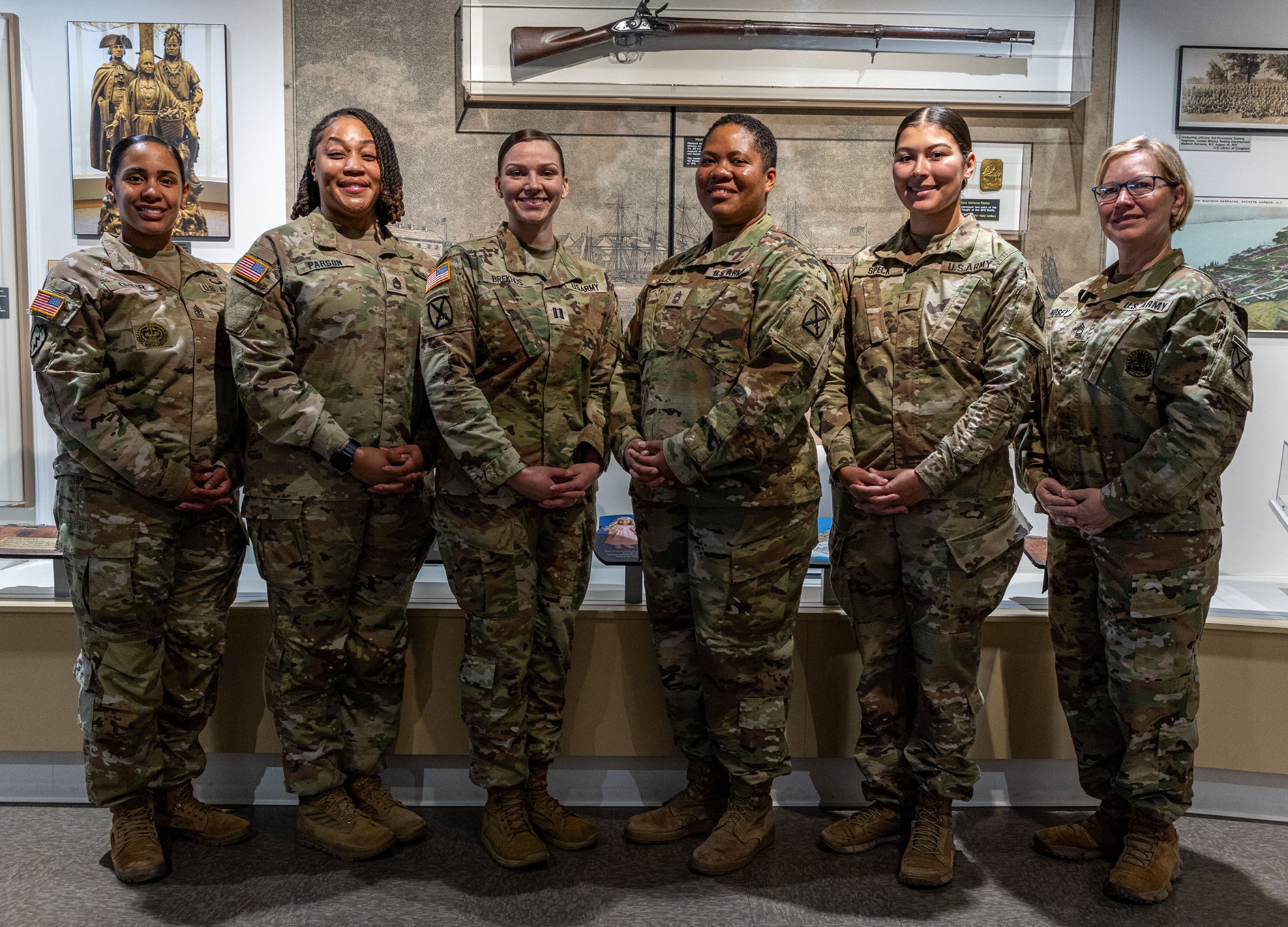 Female Soldiers who made presentation during Women Warriors event gather inside the 10th Mountain Division and Fort Drum Museum.