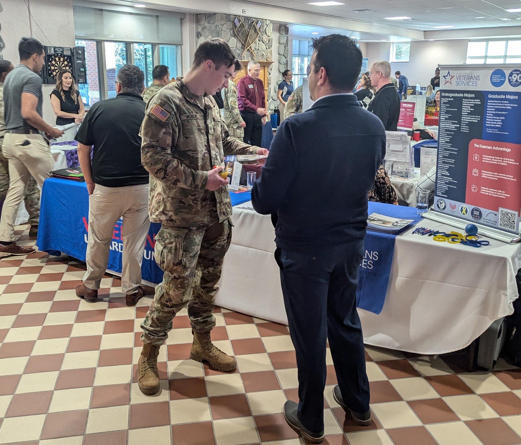 Soldiers speak with representatives at the Fort Drum Career - Education Fair.