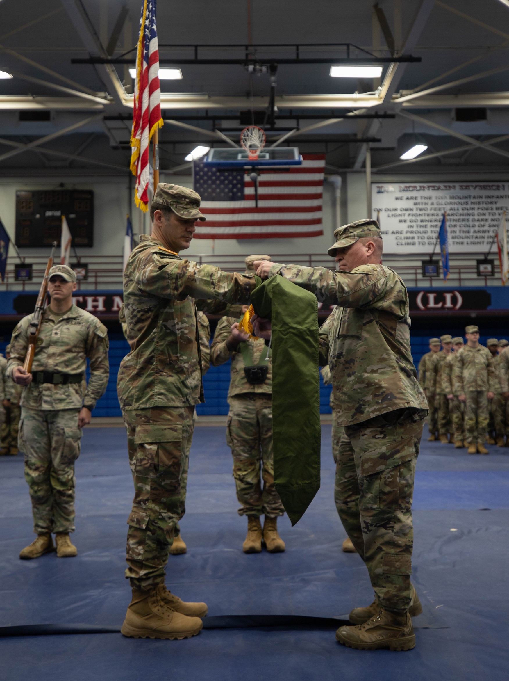 1st BCT leaders case the unit colors during a ceremony on Fort Drum.