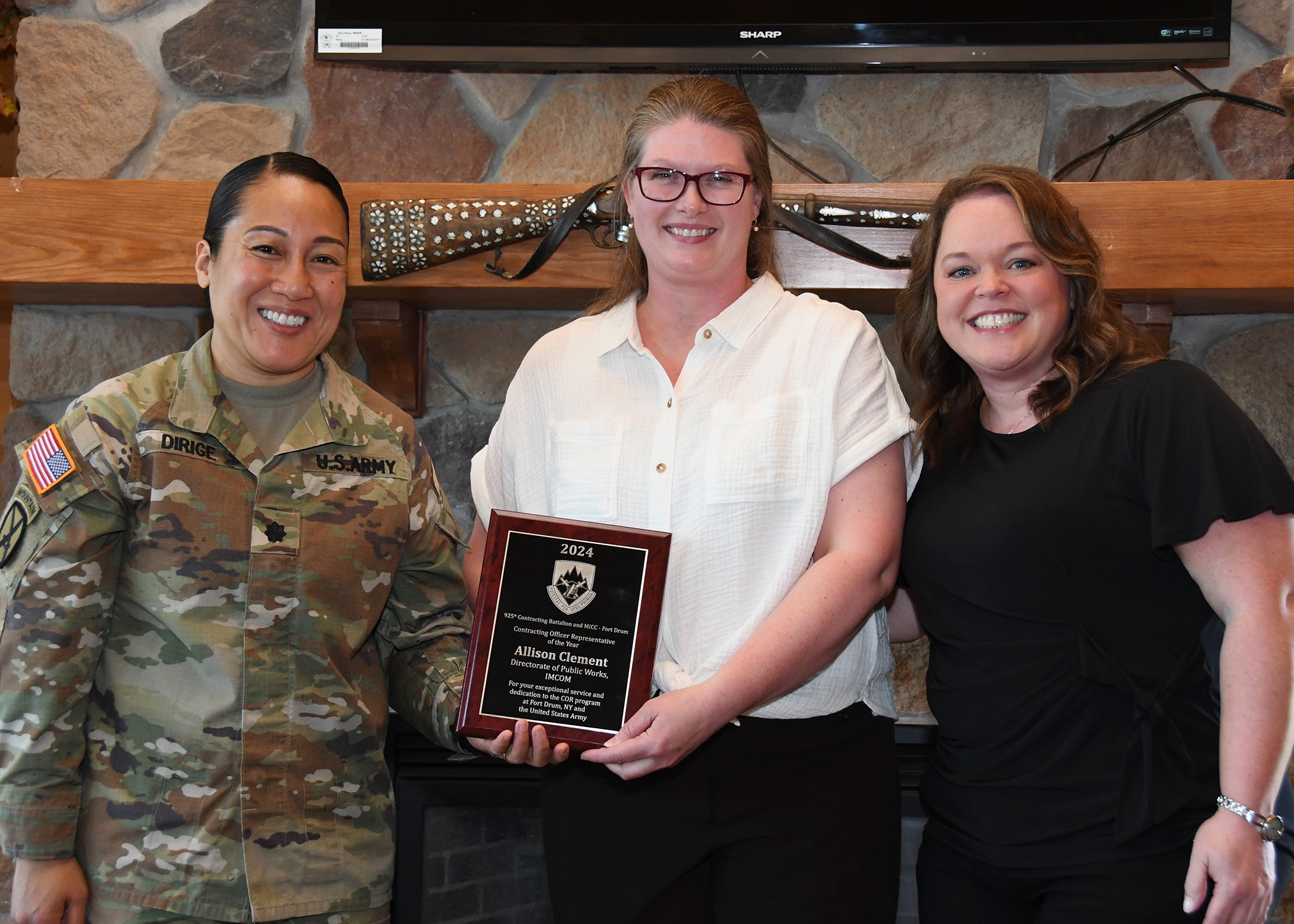 Lt. Col. Desiree Dirige presents COR of the Year.award to Allison Clement.