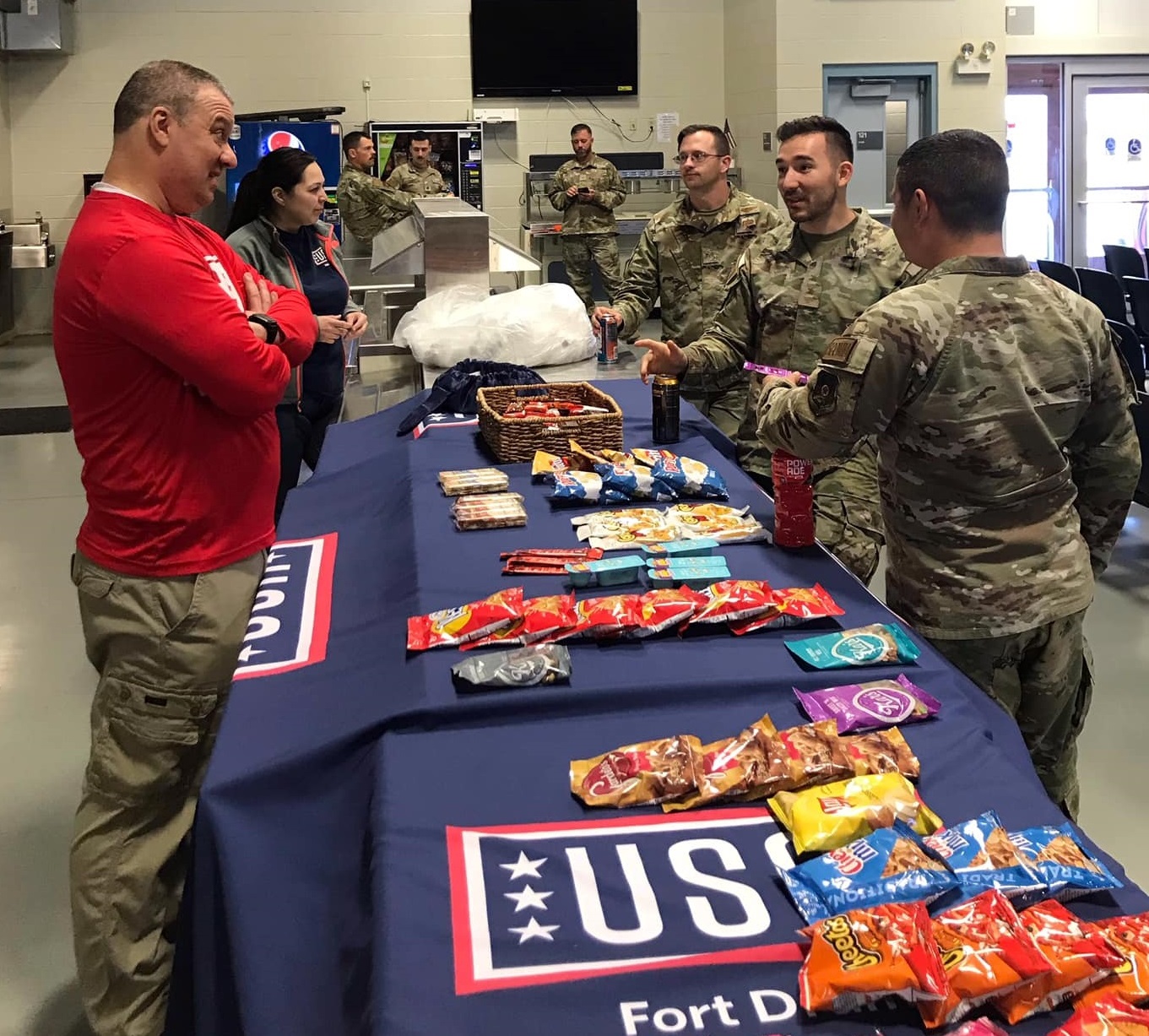 Volunteers greet Soldiers with snacks at the USO Center.