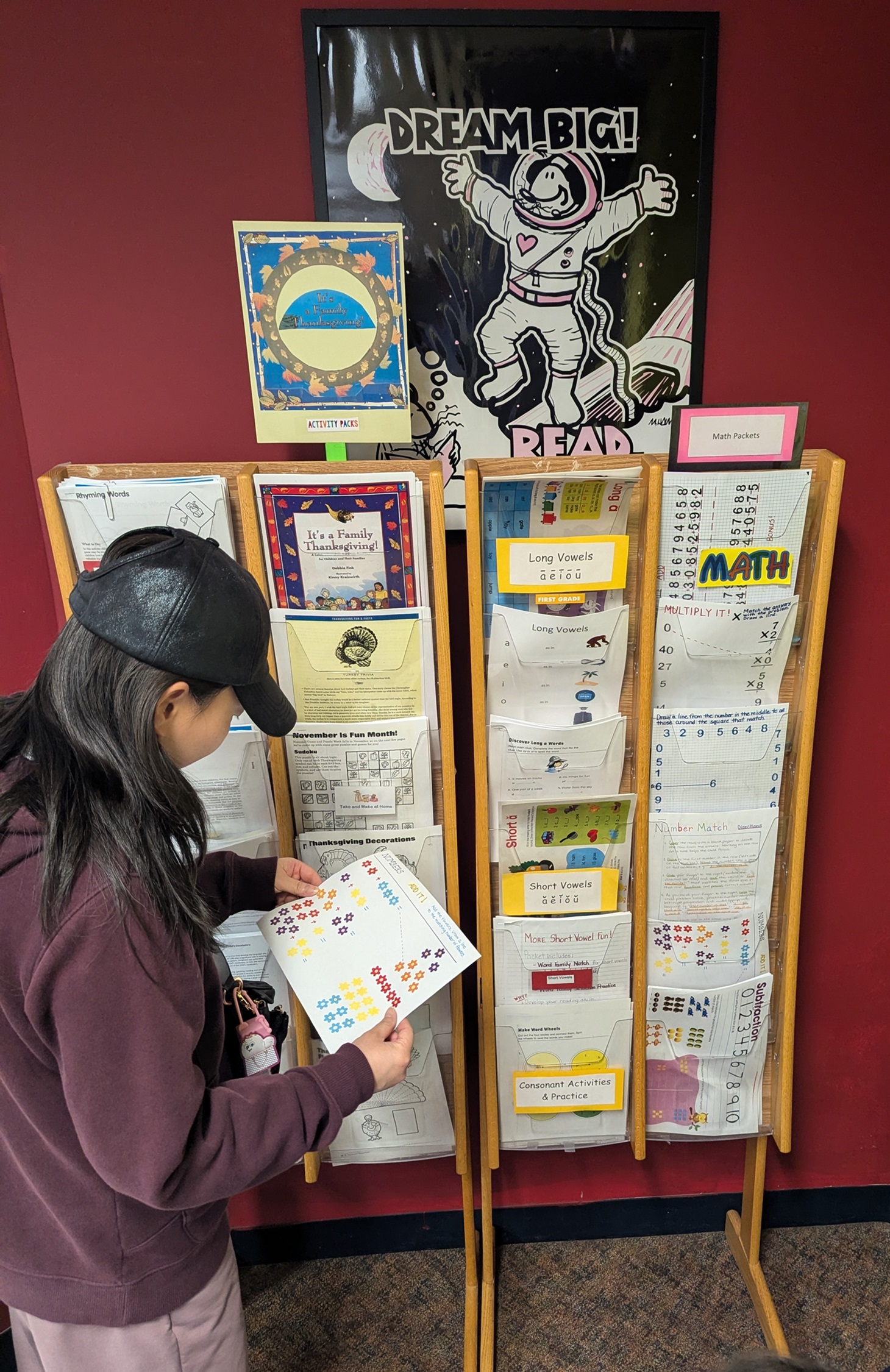Woman looks at educational products at McEwen Library.