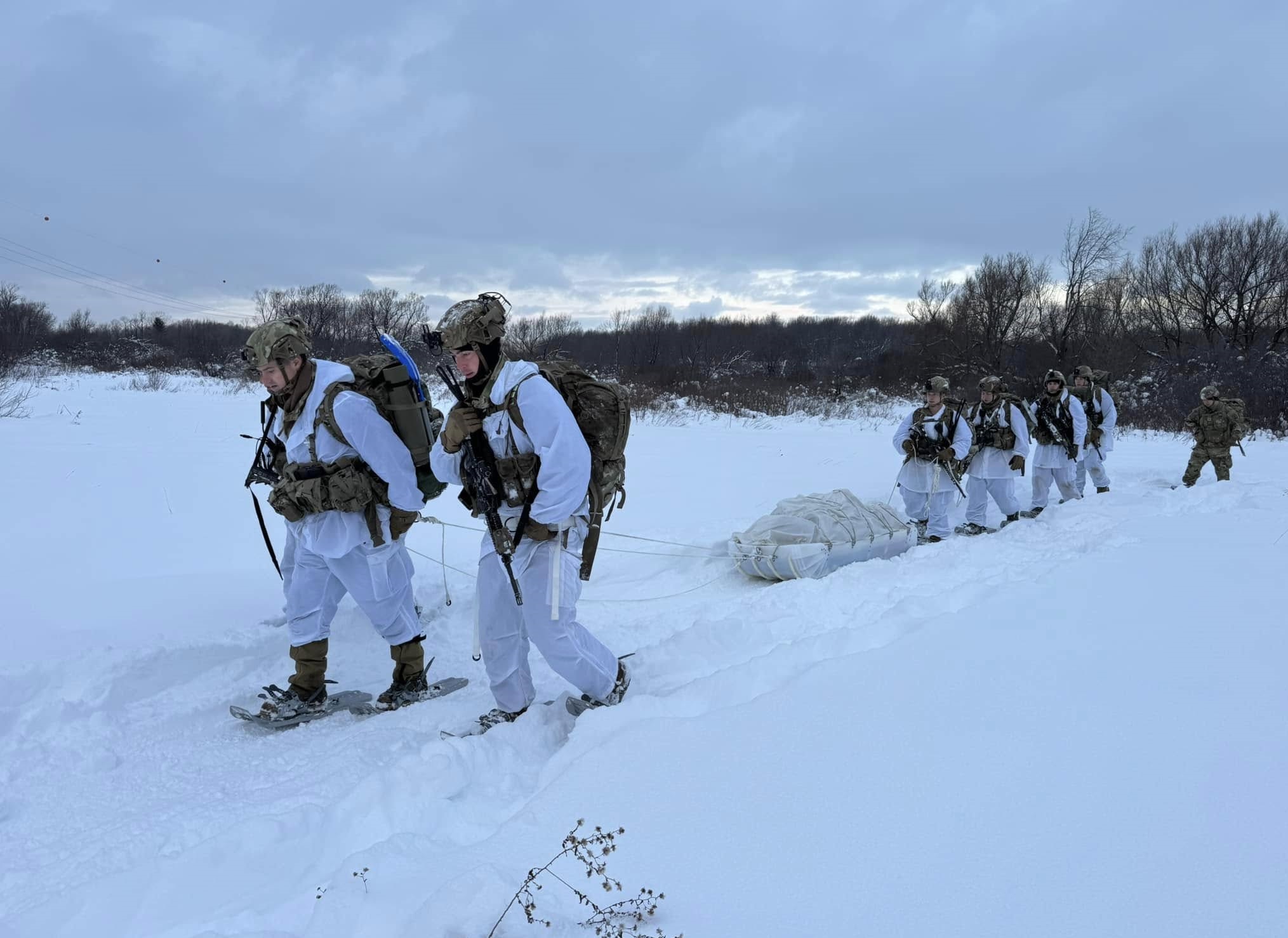 Soldiers pull Ahkio sled through the snow during alpine training at Fort Drum.