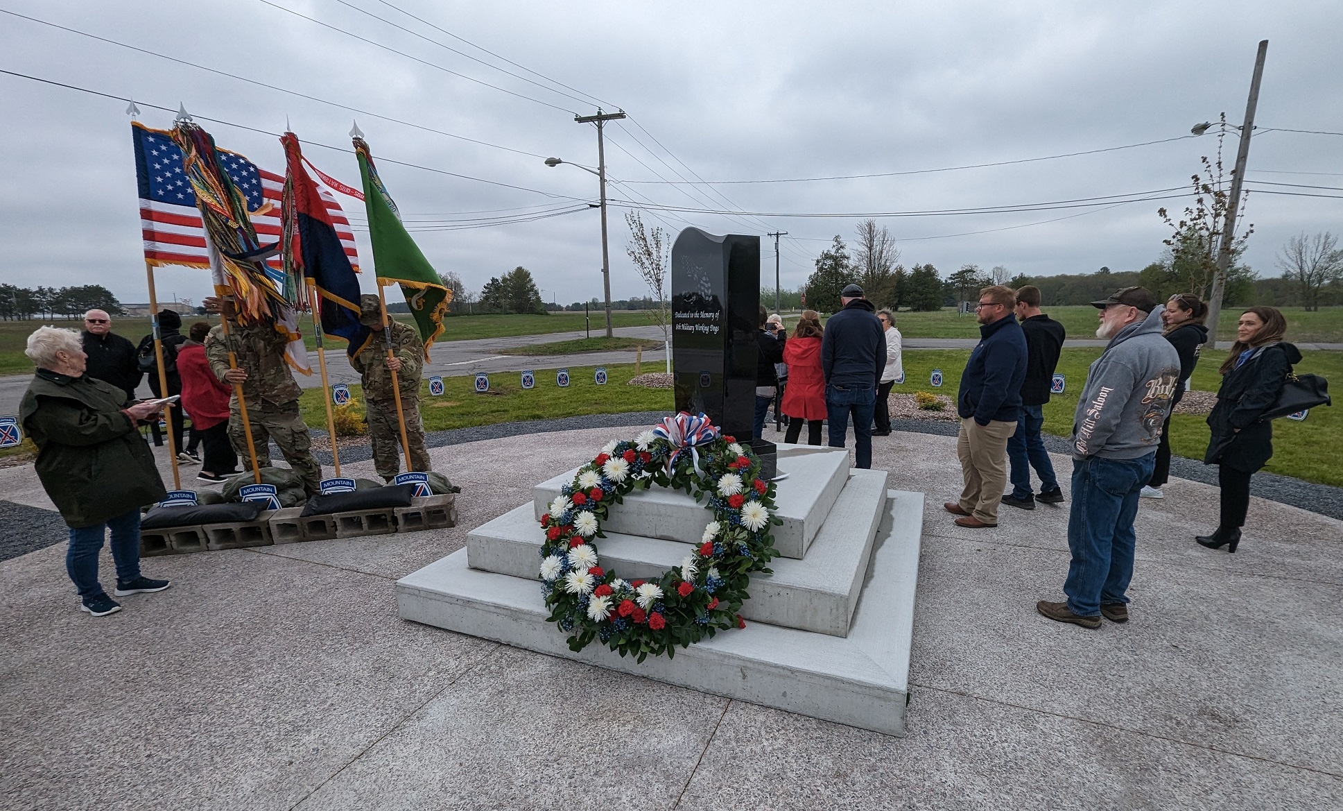 Soldiers and civilians gather around Military Working Dog Memorial for ceremony.