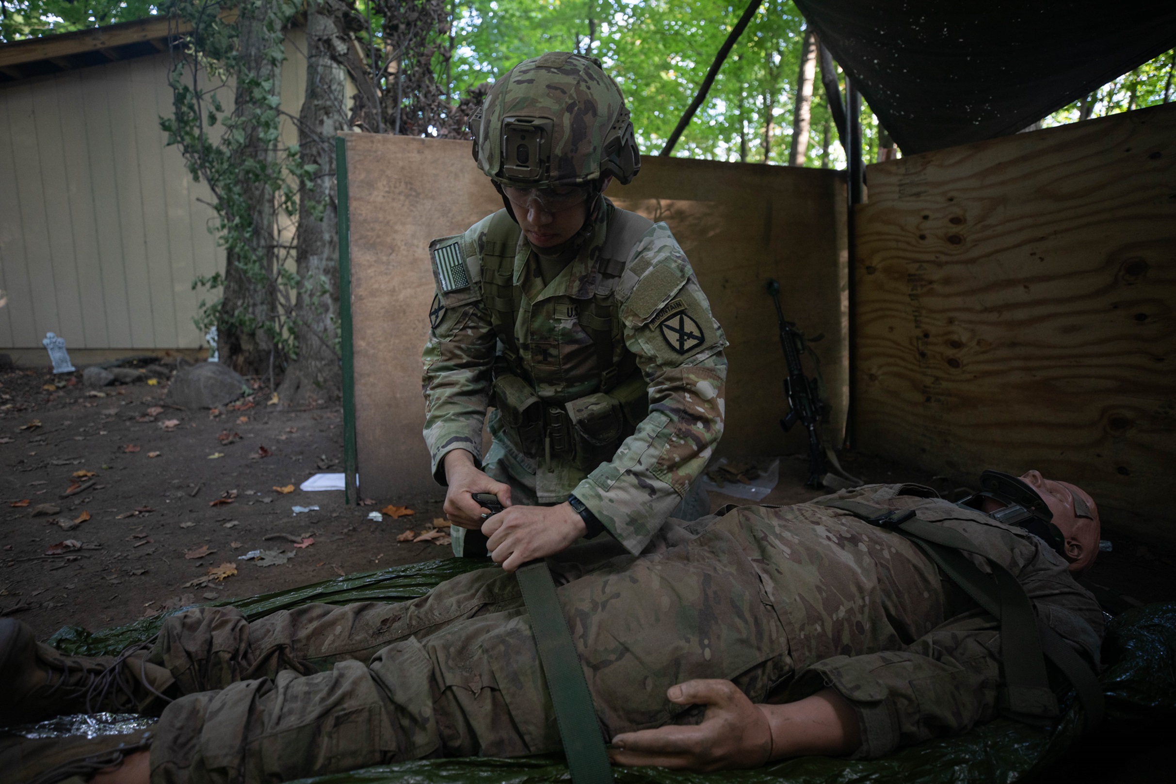 A SOldieer treats a simulated casualty during training on Fort Drum.