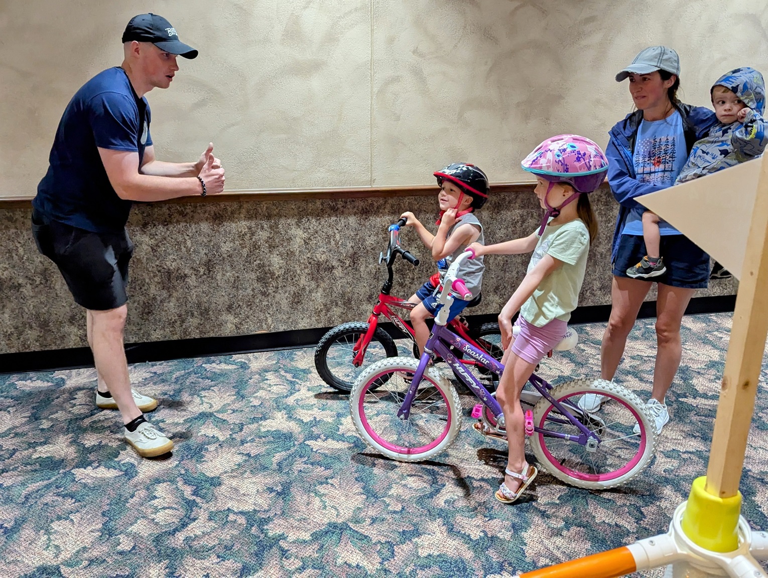 FMWR employee instructs children on bike safety.