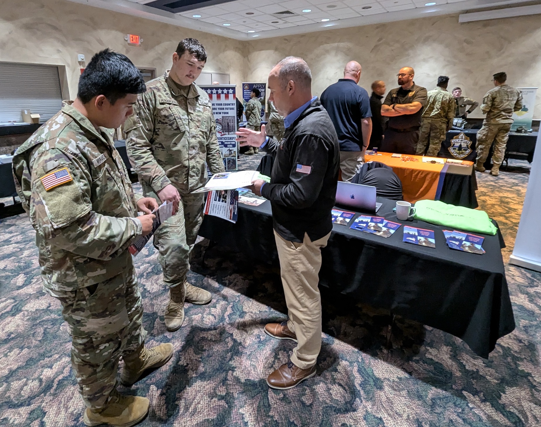 Soldiers talk with representatives at Fort Drum Career - Education Fair.