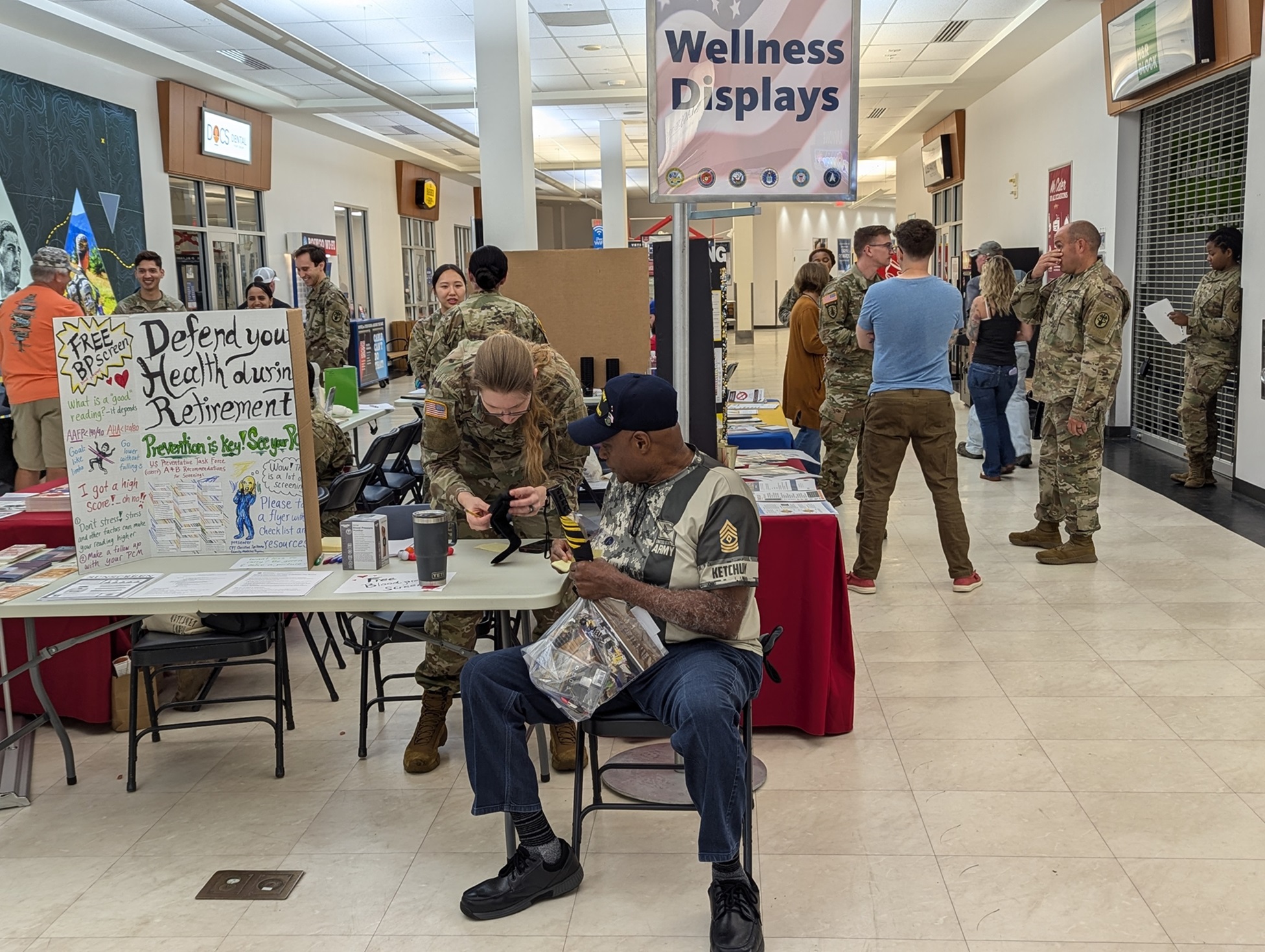 Soldiers, retirees and veterans visit booths inside the PX at the 2024 Fort Drum Retiree Appreciation Day.