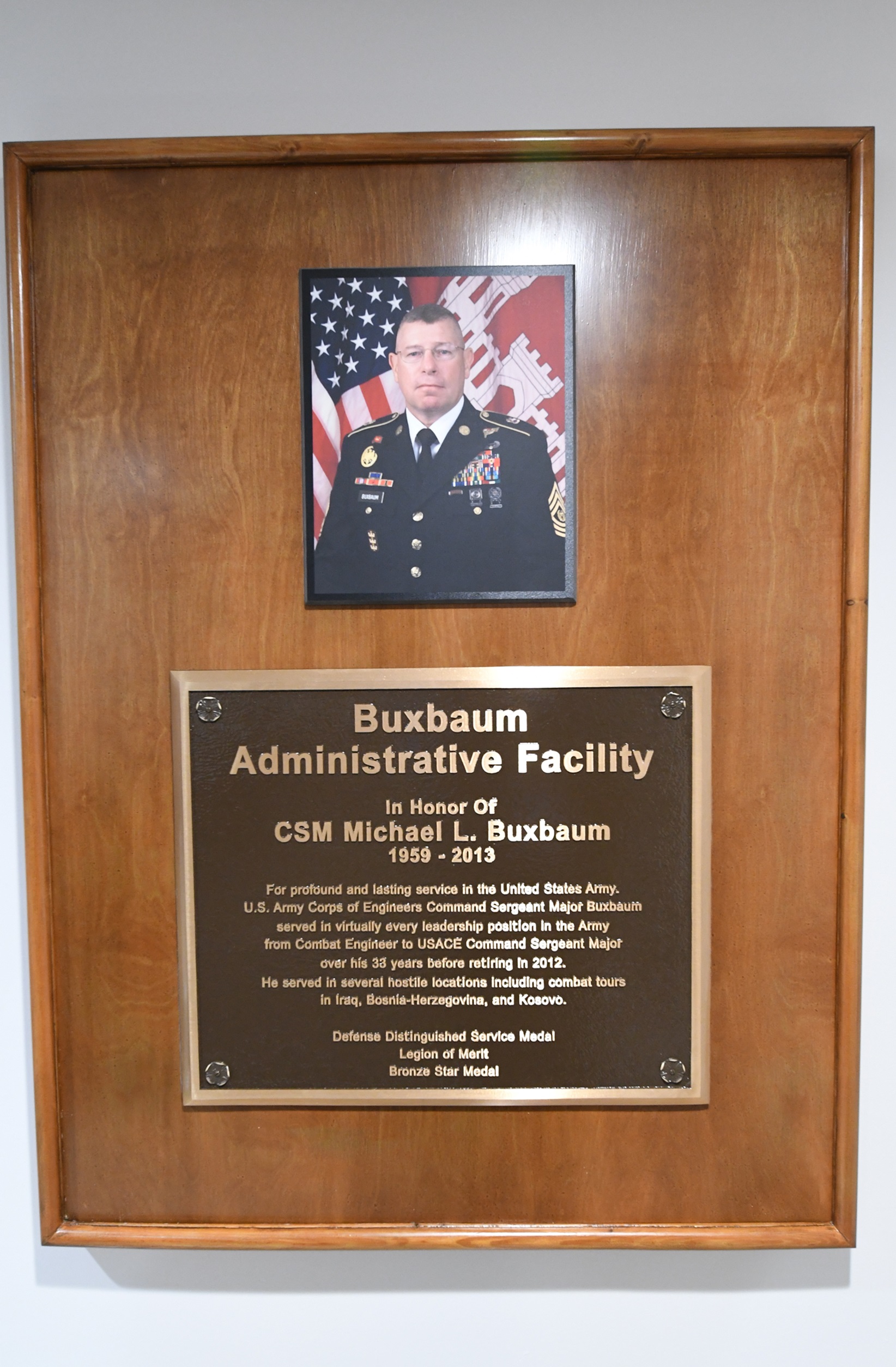 Buxbaum Administrative Facility memorial plaque on wall inside building.