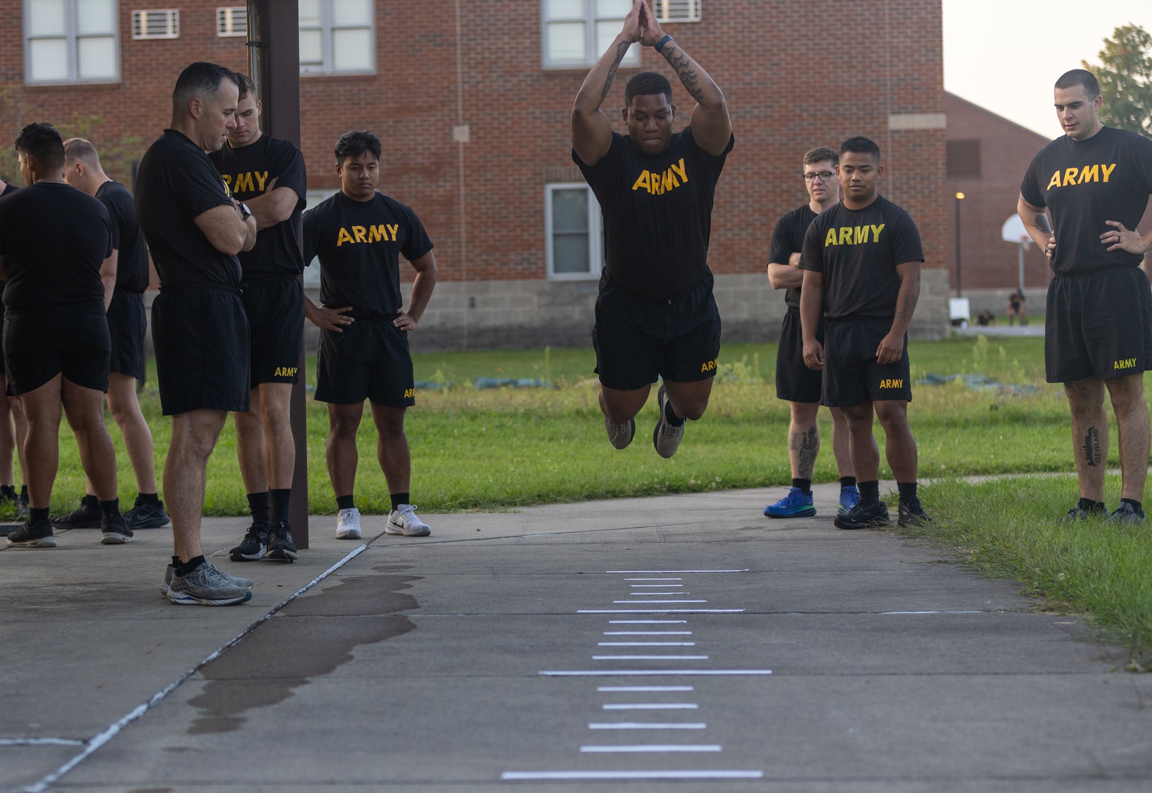 Soldier participates in physical training while others look on at Polar Bear Academy.