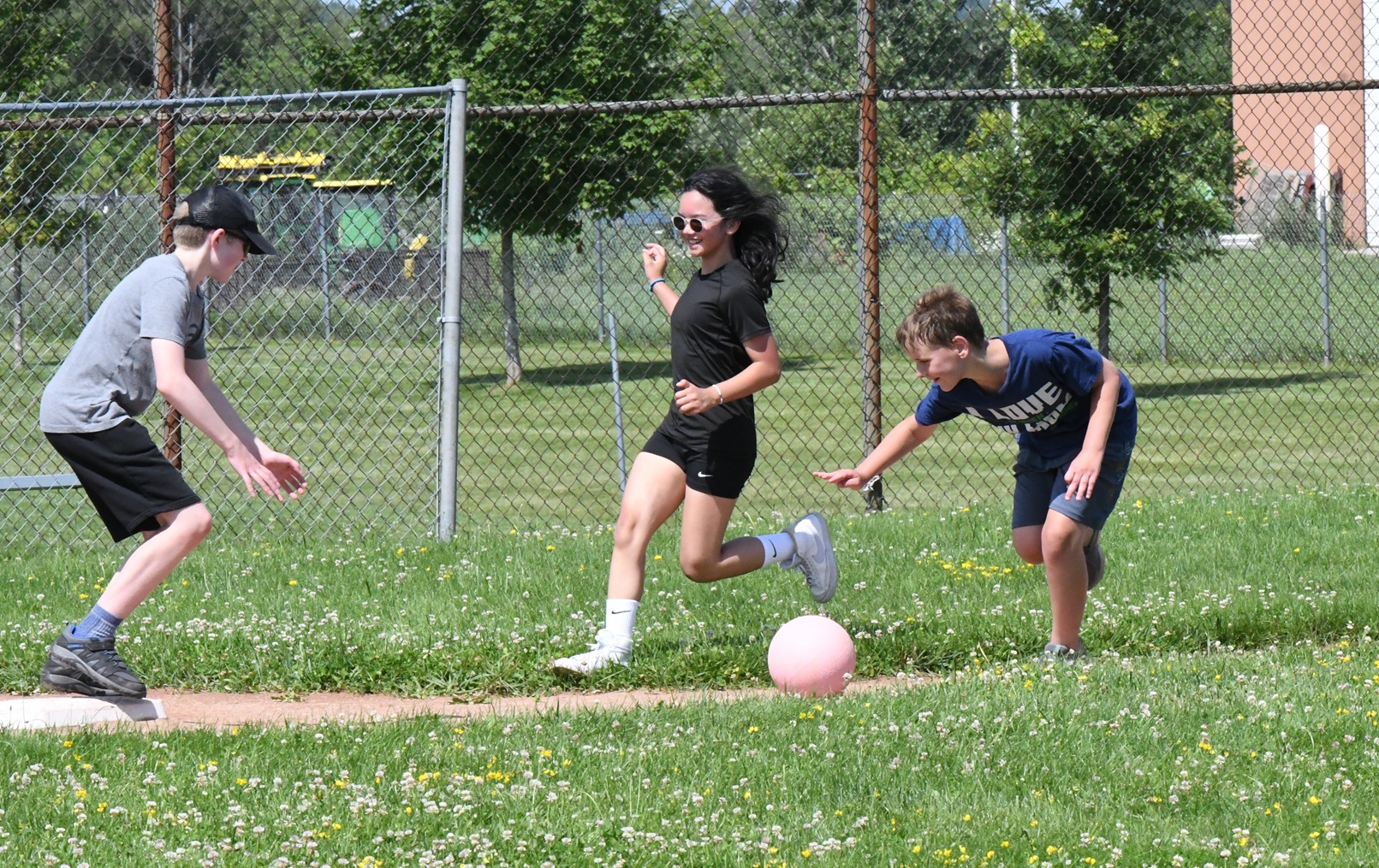 Children play kickball during CYS Summer Camp.