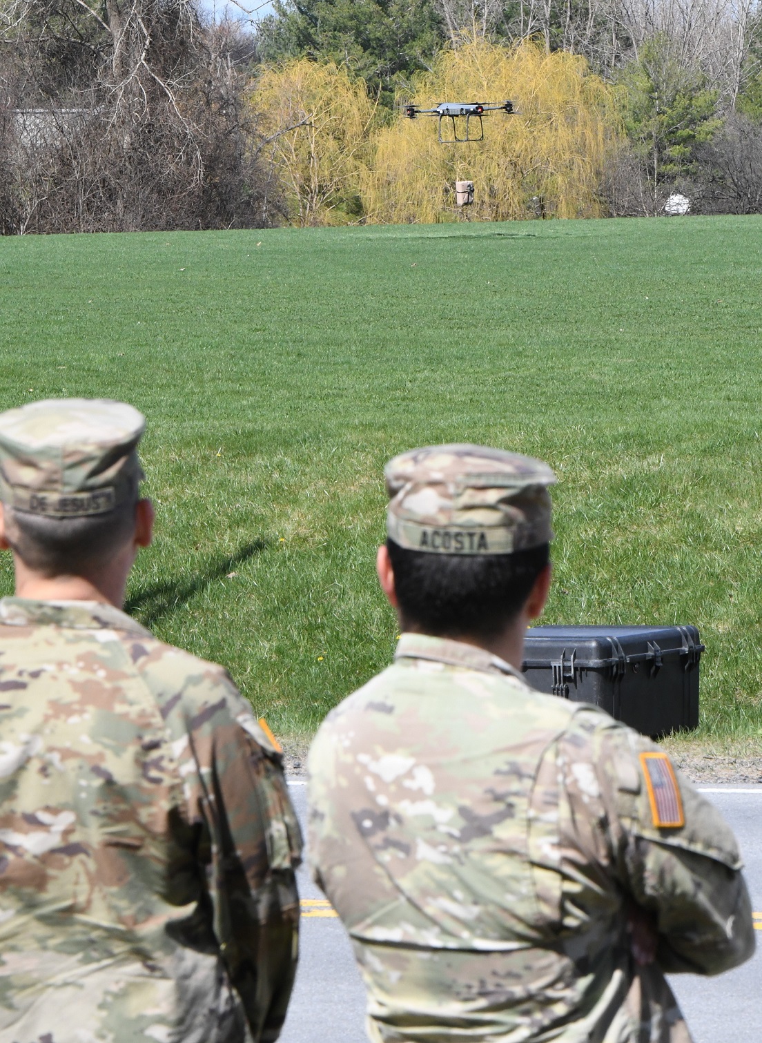 Soldiers watch tactical resupply vehicle delivering payload