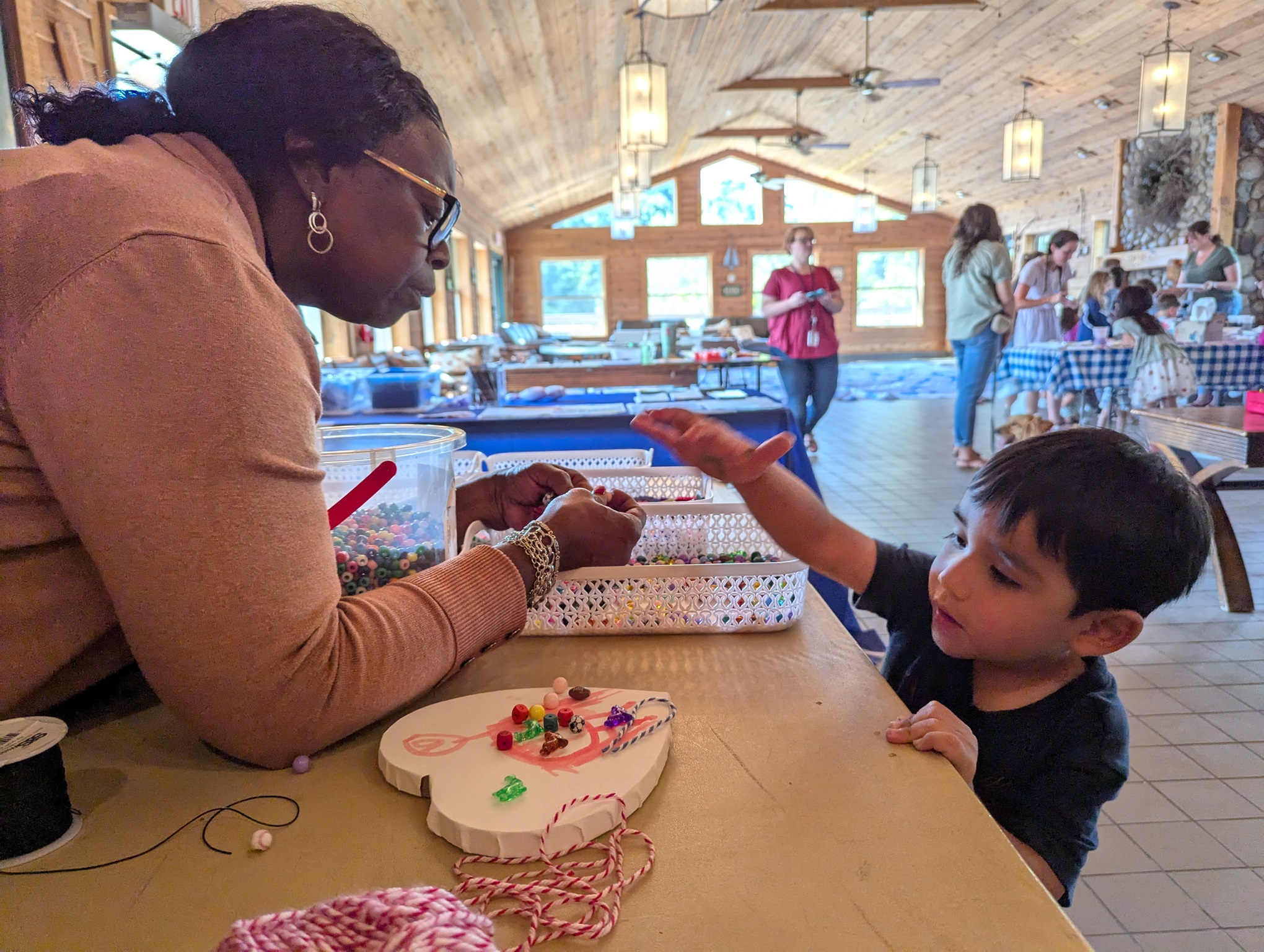 Sharon Chaple helps a family member choose beads for his project at Chill Fest.