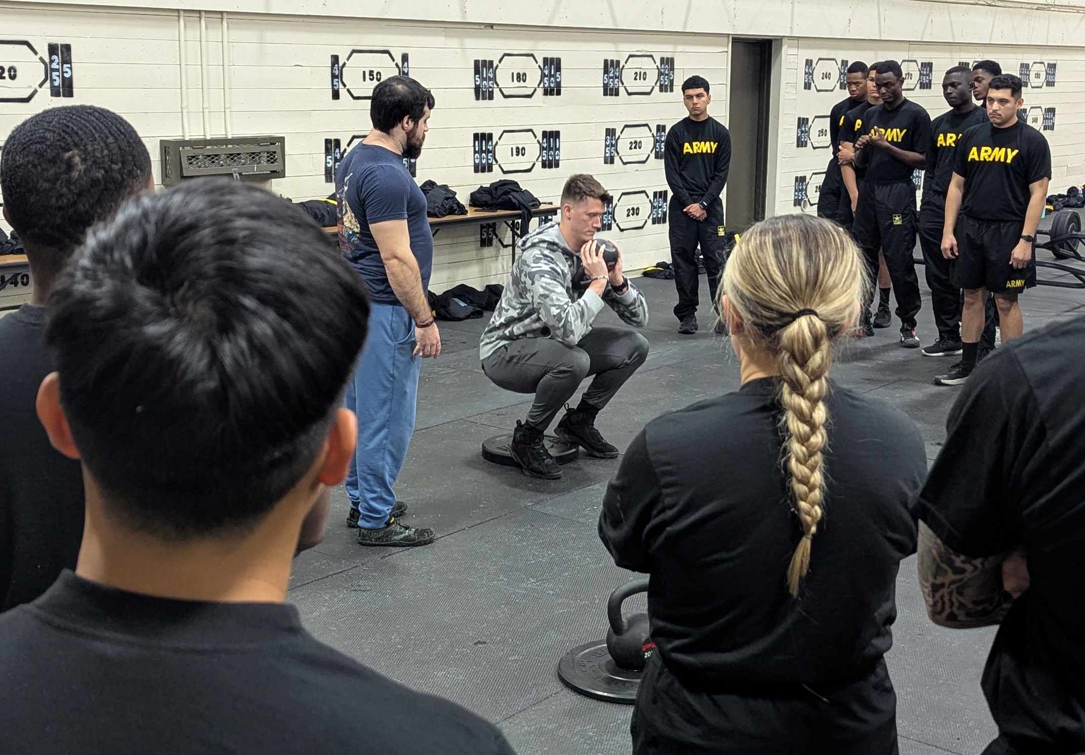 Soldier demonstrates how to do a goblet squat for incoming Soldiers at Fort Drum.