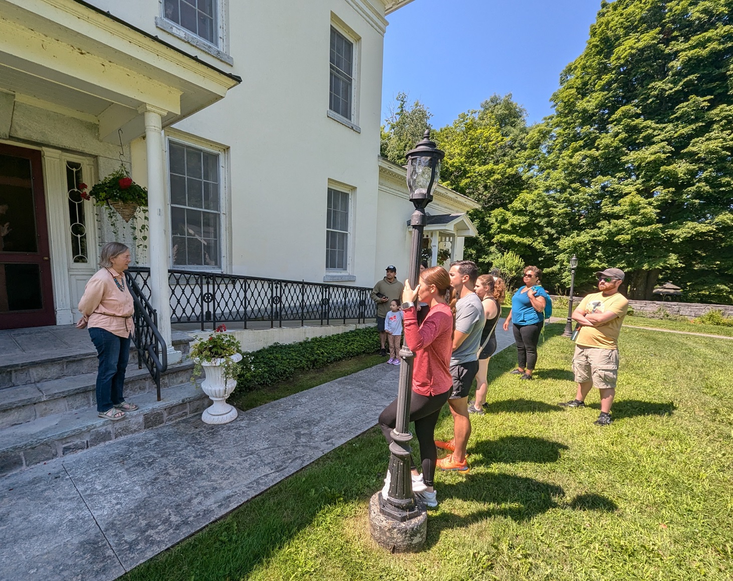 Dr. Laurie Rush welcomes visitors to LeRay Mansion at the halfway point of their walk. 