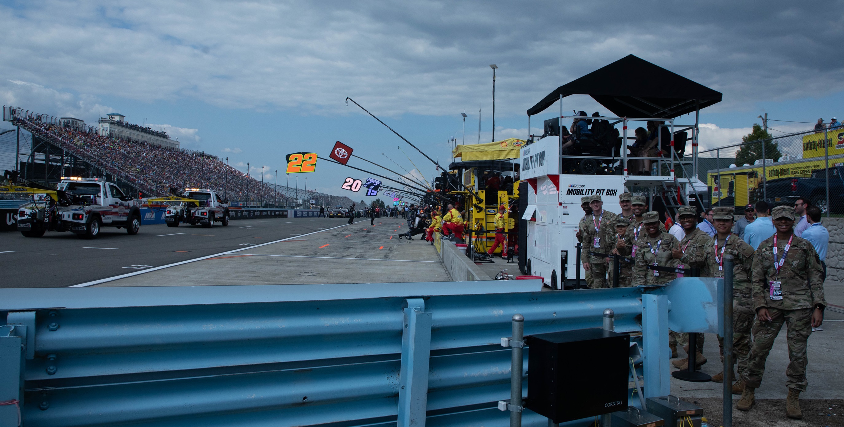 Soldiers watch the beginning of the race on pit road at Watkins Glen Internatonal.