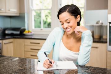 Woman writing in planner