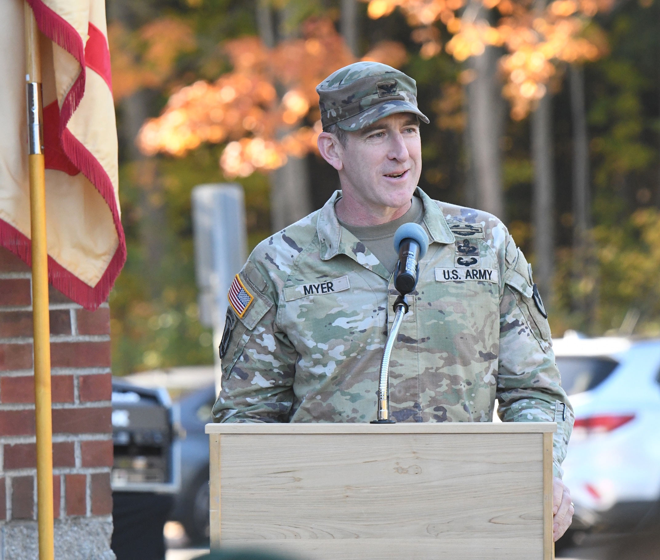 Officer speaks at podium during Buxbaum Administrative Facility memorialization.