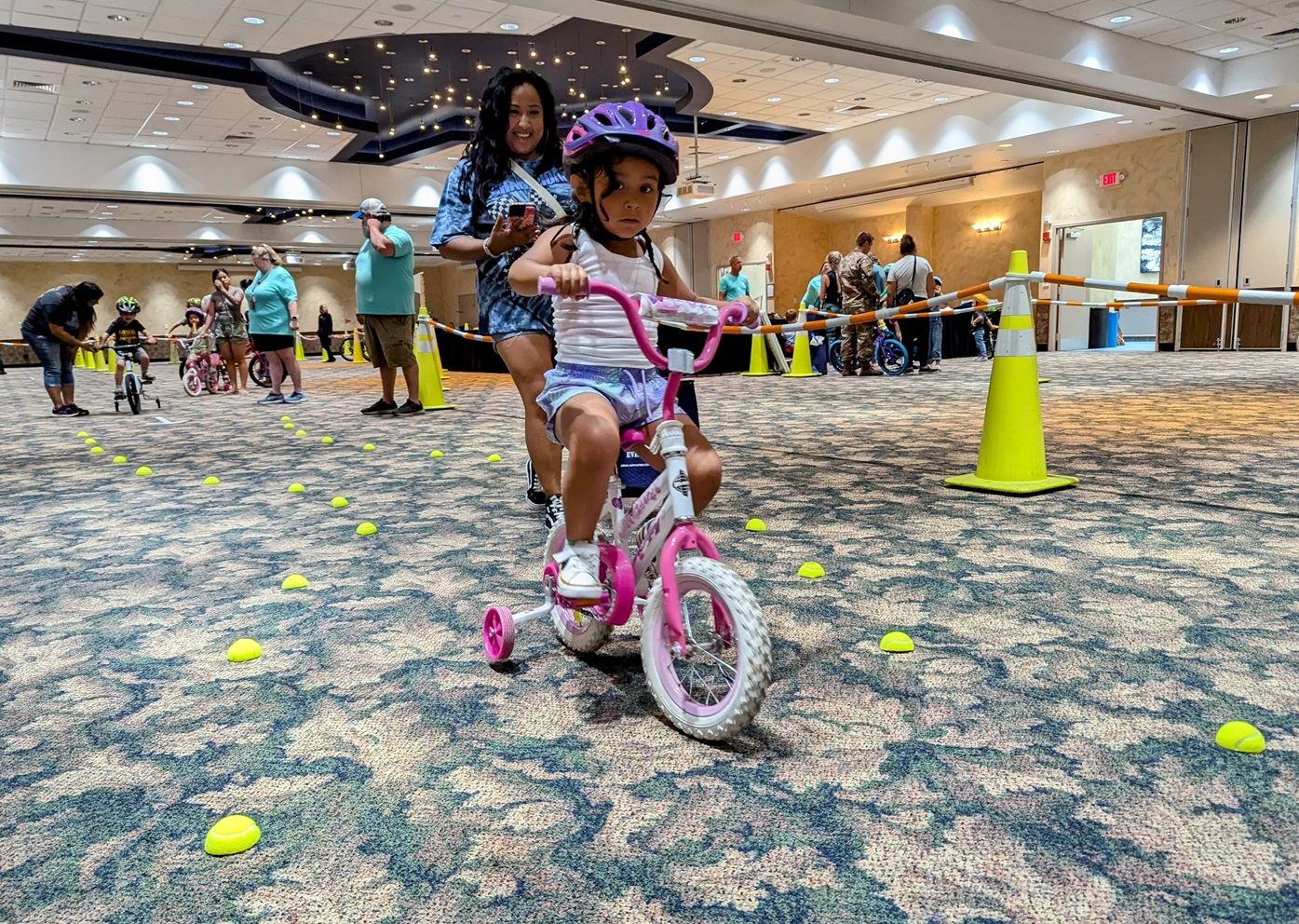 Girl rides bike through obstacle course at Bike Rodeo.