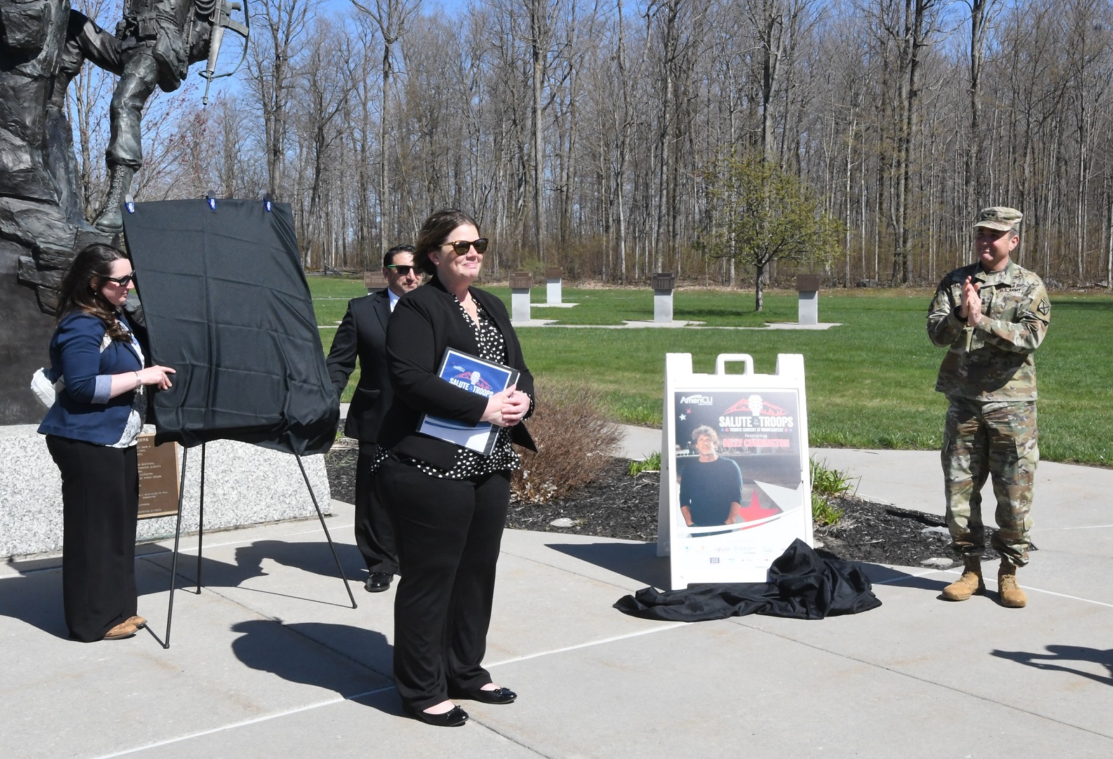 Men and women gather in park for Mountainfest Concert announcement
