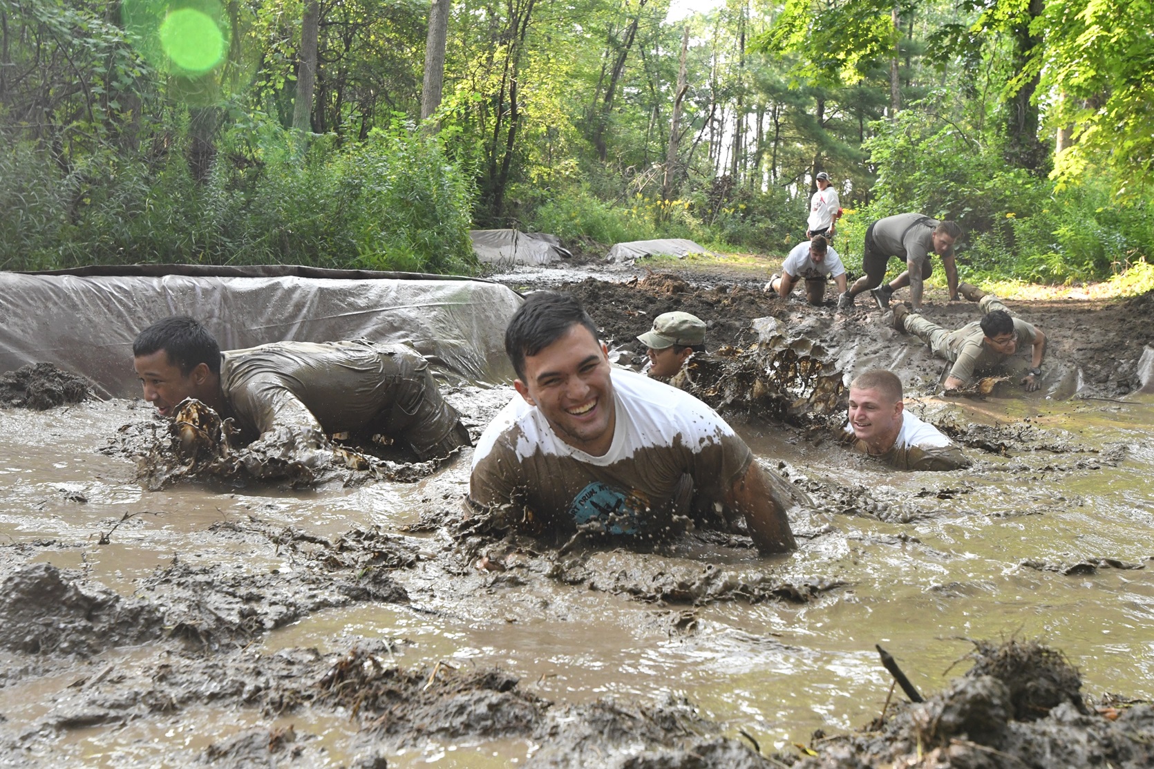 Participants slog through a muddy pit during the 2024 Mountain Mudder..