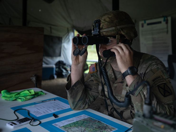 A Soldier calls for simulated artillery during training on Fort Drum.