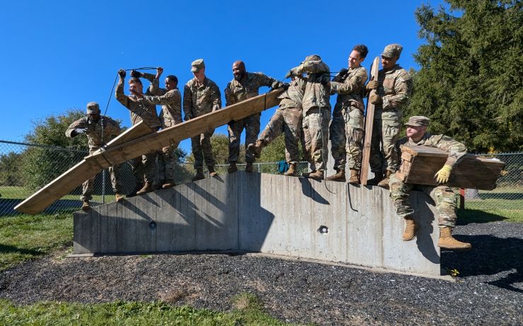 Soldiers work together to negotiate an obstacle course during TRUST Training.