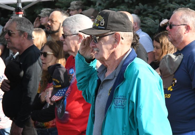 Veterans salute the flag during 2024 Fort Drum Retiree Appreciation Day.