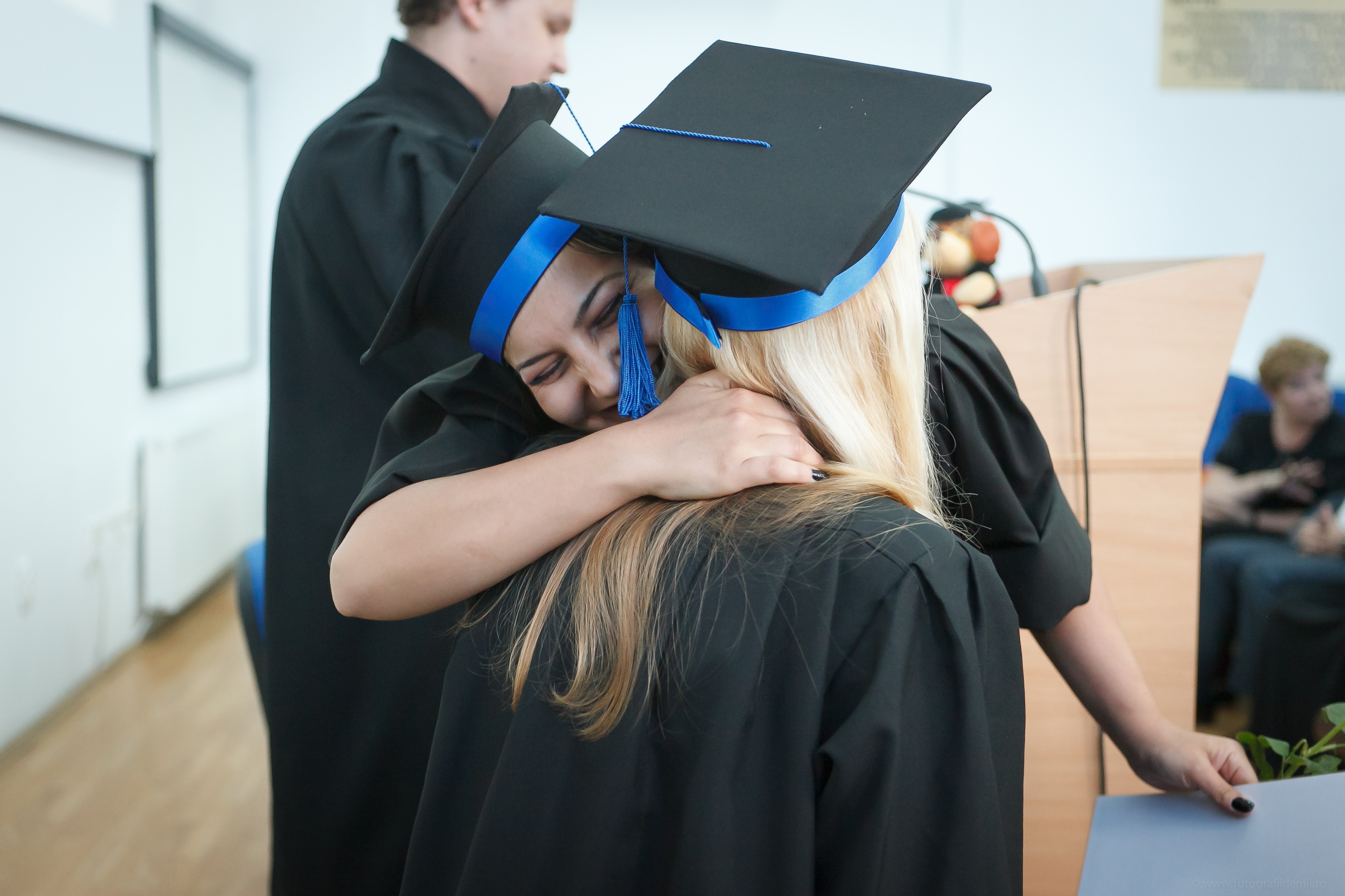 Stock photo of two female graduates hugging