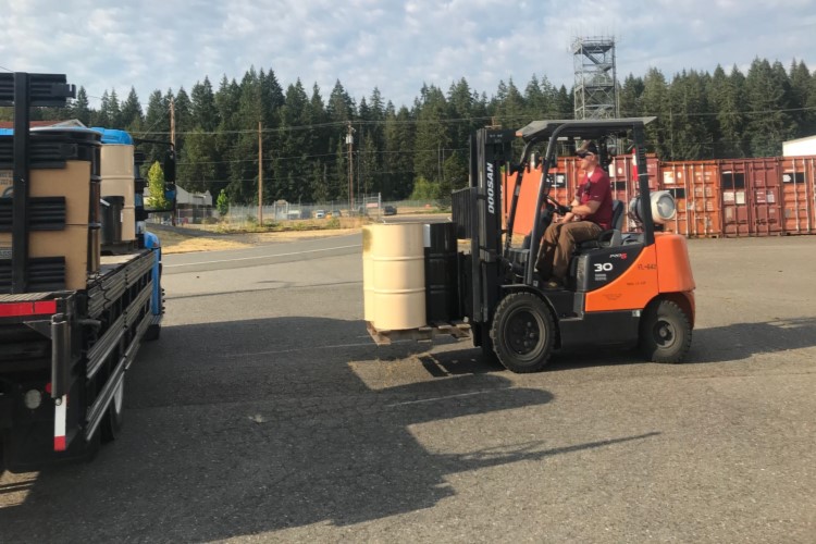 Hazardous Waste team moving barrels 