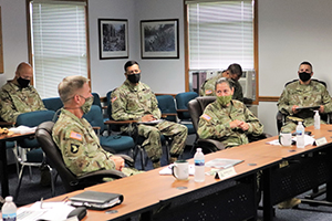 Photo: Photo by Scott T. Sturkol The 40th Chief of Staff of the U.S. Army Gen. James McConville (left) and other distinguished visitors listen in during a briefing by Garrison Commander Col. Michael Poss on Aug. 11 about the post at the Fort McCoy Garrison Headquarters.