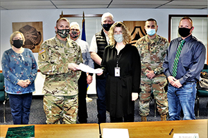 Photo: ort McCoy Resource Management Officer Maureen Richardson, Garrison Commander Col. Michael Poss, Deputy to the Garrison Commander Brad Stewart, Vernon County Highway Commissioner Phil Hewitt, Vernon County Administrator Cari Reddington, Fort McCoy Staff Judge Advocate Lt. Col. Savas Kyriakidis, and Directorate of Public Works Operations and Maintenance Division Chief Nathan Sobojinski were all on hand for the signed of an intergovernmental service agreement (IGSA) between the post and Vernon Count on March 15 at Fort McCoy. The agreement involves line striping on roadways at Fort McCoy and is estimated to save the installation more than $166,000 over the next 10 years.