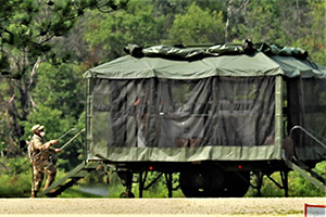 Photo: Soldiers prepare a mobile kitchen trailer for use Aug. 9 as part of operations for Combat Support Training Exercise 78-21-02 at Big Sandy Lake on South Post on Fort McCoy.