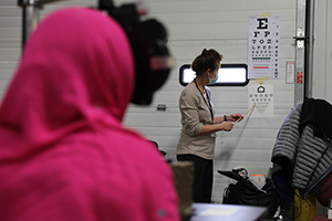 Photo: Cheryl Lubach, a Wisconsin Lions Club volunteer, gives an Afghan evacuee an eye exam during an optometry clinic Nov. 12 at Fort McCoy as part of Operation Allies Welcome.