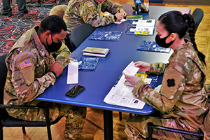 Photo: Soldiers fill out Army Emergency Relief (AER) donation forms Feb. 17 during the 2022 AER Campaign Kick-off Breakfast at McCoy’s Community Center at Fort McCoy.