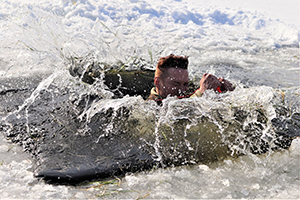 Photo: A student participates in cold-water immersion training Jan. 31 at Big Sandy Lake at Fort McCoy.