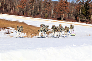 Photo: A squad of Airmen participating in Cold-Weather Operations Course class 21-04 participate in a training scenary Feb. 26 on South Post.